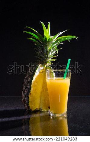 A glass of Pineapple juice on black background