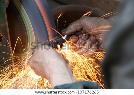 blacksmith polishing metal piece