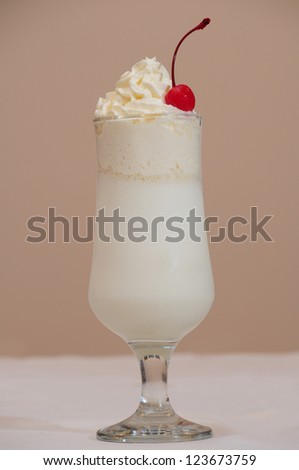Milk cocktail with maraschino cherry