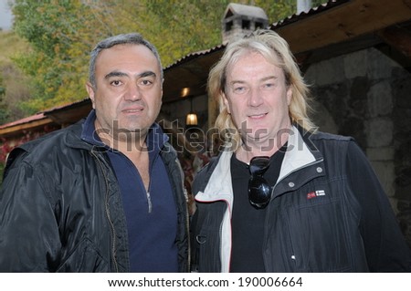 SPITAK, ARMENIA - OCTOBER 1: Geoff Downes of Yes/Asia and one of his fans on October 1, 2009 in Spitak, Armenia. He visits Armenia within the framework of “Armenia Grateful 2 Rock” project.