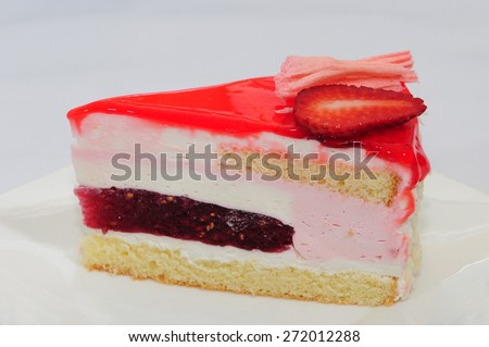 A wedge of strawberry mousse cake