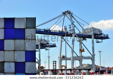 Cargo cranes are working at the port of Auckland, New Zealand.