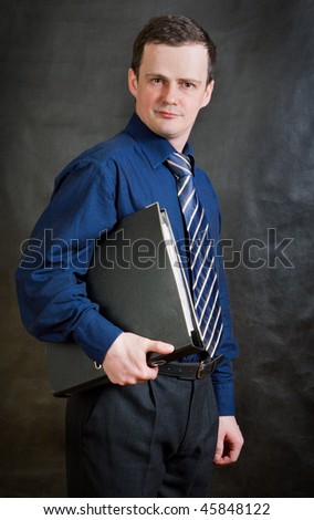 The young man in business clothes holds two hands office folder with papers