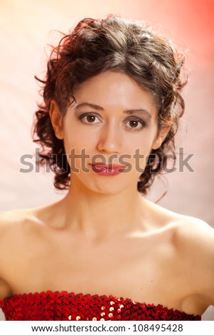 portrait of the young dark-haired girl in studio on color background
