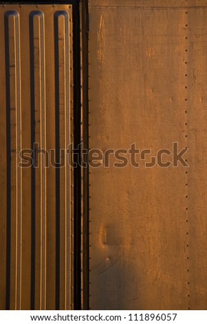 Abstract composition of corrugated metal walls of storage trailer. Photographed on Tybee Island, Georgia, USA.