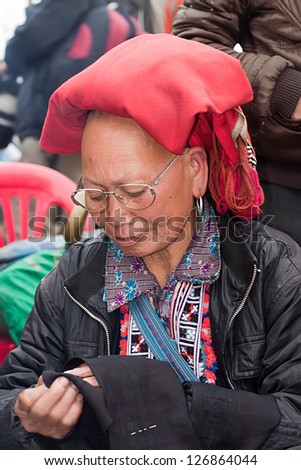 SAPA, VIETNAM - FEB 11: Unidentified woman from the Red Dao Ethnic Minority People on  February 11, 2012 in Sapa, Vietnam. Red Dao Minority are the 9th largest ethnic group in Vietnam