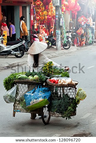 HANOI, VIETNAM - FEBRUARY 3: Unidentified vendor at the small market on February 3, 2013 in Hanoi, Vietnam. This is a small market in Tet Lunar New Year celebrations of vietnam