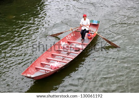 HANOI VIETNAM March 2. Man rowing boat. March 2, 2013 in Hanoi, Vietnam. Boat is a common means of transport in Vietnam