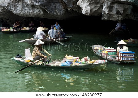NINHBINH, VIETNAM, MAY 12: Unidentified woman, own her little shop on boat in Tamcoc on May 12, 2013 in Ninhbinh, Vietnam. Tamcoc is a famous place in Ninhbinh province
