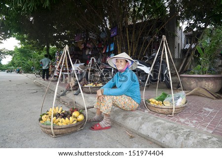 HANOI, VIETNAM - JULY 31: Unidentified supplier of bananas in the small market on July 31, 2013 in Hanoi, Vietnam. This is a small market in the New Year Lunar New Year celebrations in Vietnam