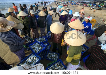 HALONG, VIETNAM - AUGUST 14: A lot of fishers sort out their catch on the shore and sell fish to dealers, August 14, 2013, HaLong, Vietnam