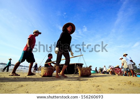 HALONG, VIETNAM - AUGUST 14: Fishermen sort out their catch on the shore and sell fish to dealers, August 14, 2013, HaLong, Vietnam
