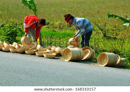 NAMDINH, VIETNAM DECEMBER 21: Workers exposed bamboo handicrafts in the sun in Namdinh, Vietnam on December 21, 2013. Bamboo crafts are major export items of Vietnam