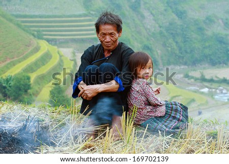 MUCANGCHAI, VIETNAM - October 6: Hmong men and a little girl named VangSi-5-year-old on October 6, 2013 at Mucangchai, Vietnam. The Hmong are one of the largest ethnic groups in northern Vietnam