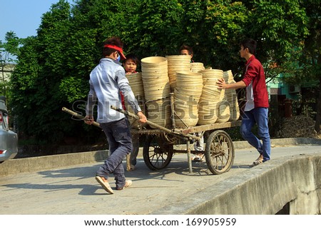 NAMDINH, VIETNAM DECEMBER 21: Workers exposed bamboo handicrafts in the sun in Namdinh, Vietnam on December 21, 2013. Bamboo crafts are major export items of Vietnam