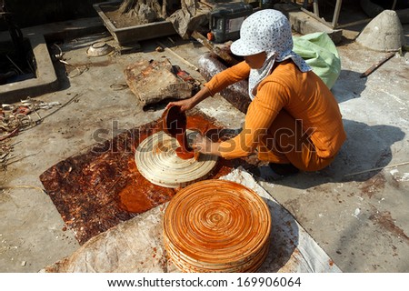 NAMDINH, VIETNAM DECEMBER 21: Worker exposed bamboo handicrafts in the sun in Namdinh, Vietnam on December 21, 2013. Bamboo crafts are major export items of Vietnam