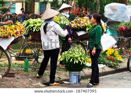 NAMDINH, VIETNAM - APRIL 13: Unidentified small flower vendor at the flower market on April 13, 2014 in Namdinh, Vietnam. This is a small market for retail florists and street vendors.