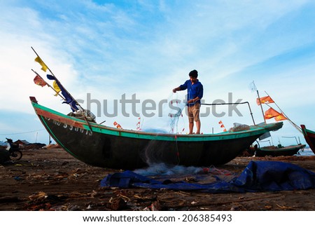 NAMDINH, VIETNAM - JULY 4: Fishermen working in the fishing village on sunset of Hai Hau, vietnam