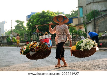 NAMDINH, VIETNAM July 26. 2014 : Unidentified flower vendor at the flower small market in Namdinh, Vietnam. This is a small market for retail florists and street