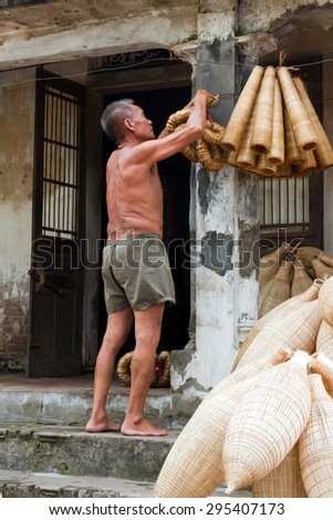 HUNGYEN, VIETNAM - JUNE 21 2015 :Unidentified man was weaving bamboo in HungYen, Vietnam. Weaving this tools that used to catch fish is traditional occupation in Hung Yen province.