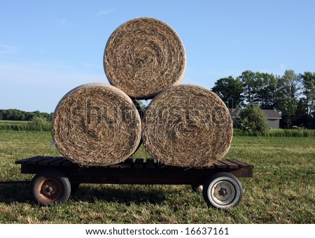 round hay bales loaded on a flat trailer