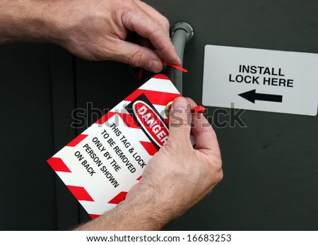 electrician placing a lock out tag on electrical equipment