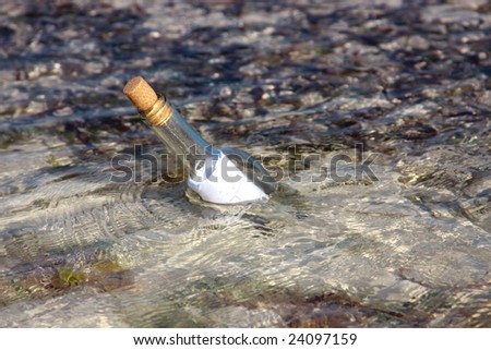message in a bottle floating on the ocean waves
