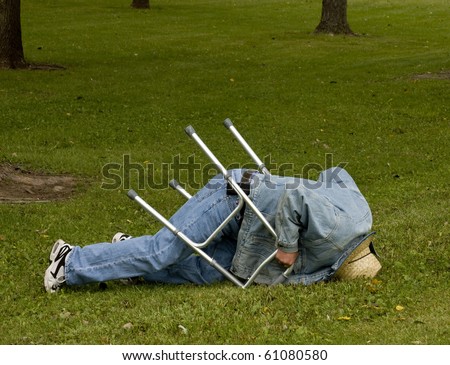 elderly man falls down with a walker on a lawn
