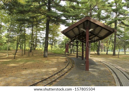 train station with trees and a shelter in the background