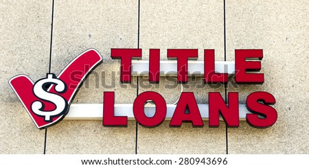Marshfield, Wisconsin, May, 22, 2015  Title Loans Sign on a building store front.  Title Loans is a lending service that specializes in high risk loans at a high interest rate,