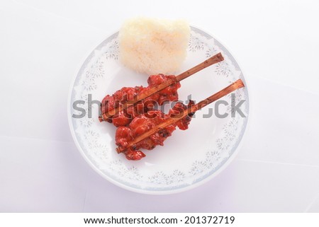 Grilled chicken skewers with sticky rice on plate.Easy breakfast for Thailand