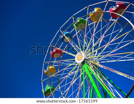 View of a still ferris wheel on a sunny day at a carnival.