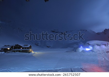 Night Sky With Old Wood Cabin and Ice Hotel in winter scene