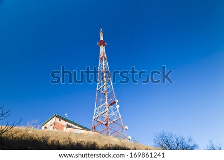 The television tower costs on the mountain in beams of a bright sun