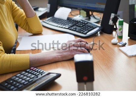 The woman at office behind work with documents and the computer