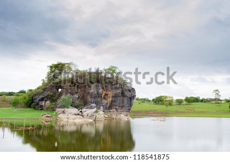 Huge rock on lake, with trees on top of it in mocambeiro, Minas Gerais - Brazil.