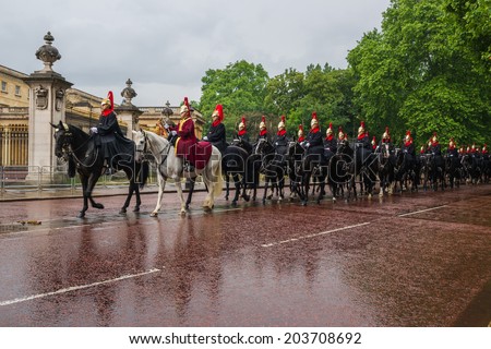 LONDON, UK - JUNE 7, 2014: Queen\'s cavalry guards march in front of Buckingham palace to Celebrate Queen\'s Official Birthday. On June 7, 2014 in London, UK.
