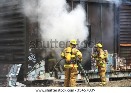 Firemen putting out a fire in a railway car