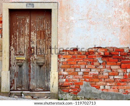 Old ruined door in brick wall background