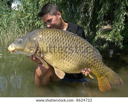 Fisherman with his big common carp