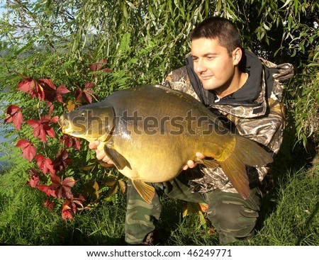 Happy fisherman with his big carp