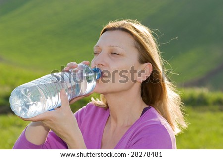 Lady drinking water from a bottle