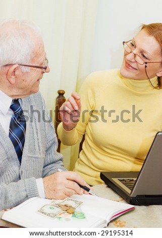 Senior talking to financial planner at home