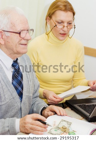 Senior talking to financial planner at home