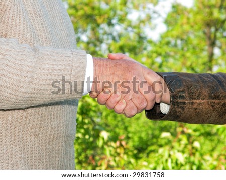 Handshake between  senior man and  middle aged lady