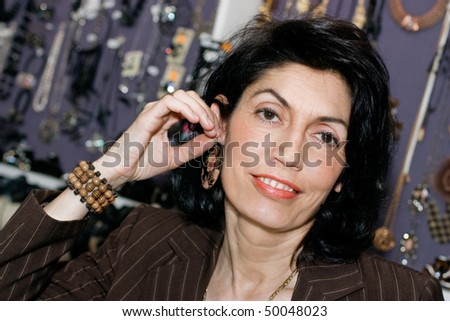 Attractive Female sales clerk with ear ring  in a bijouterie shop