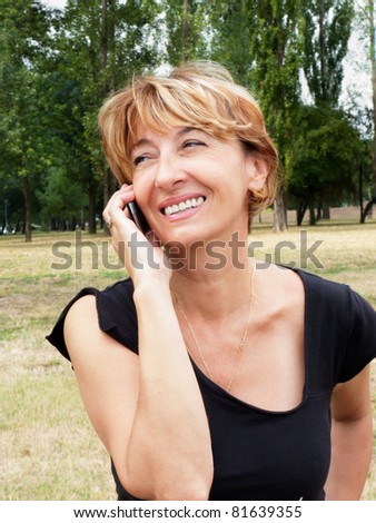 stock photo : Charming Mature woman talking by mobile outdoors. stock photo charming mature woman talking by mobile outdoors 81639355 stock photo : Charming Mature woman talking by mobile outdoors.