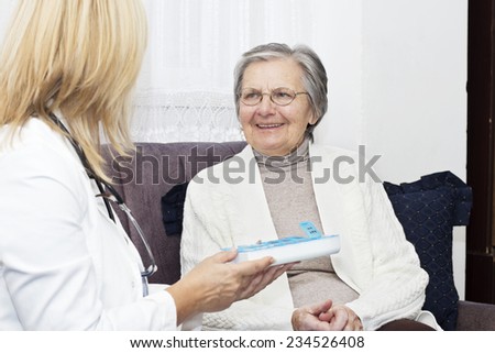 Happiness senior women sitting on the sofa and talking with her home caregiver.