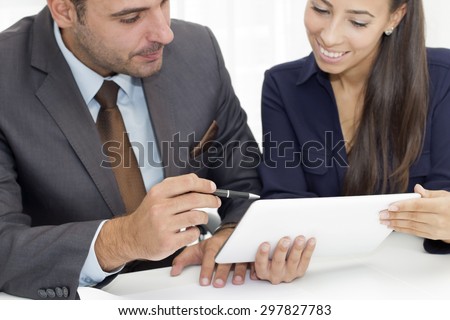 Closeup of two  business person  working  on a digital tablet.