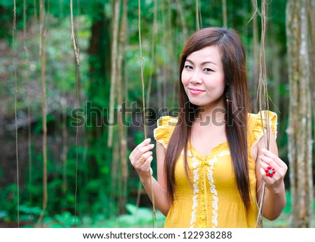 Portrait of Asian women standing in front of scenic jungle in Thailand forest